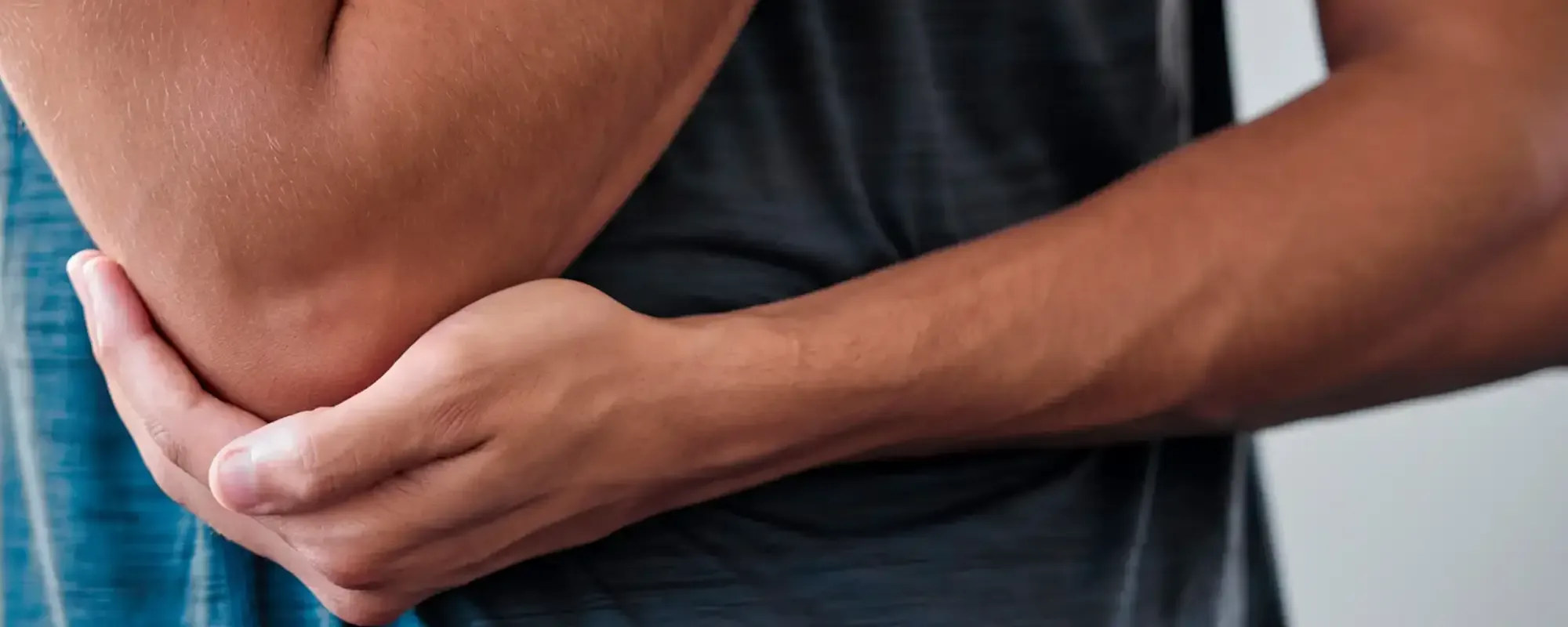 A man cradling his elbow