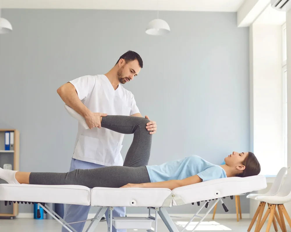 A licensed physical therapist measuring joint range of motion during an orthopedic evaluation at King Physical Therapy and Fitness in Connellsville, PA