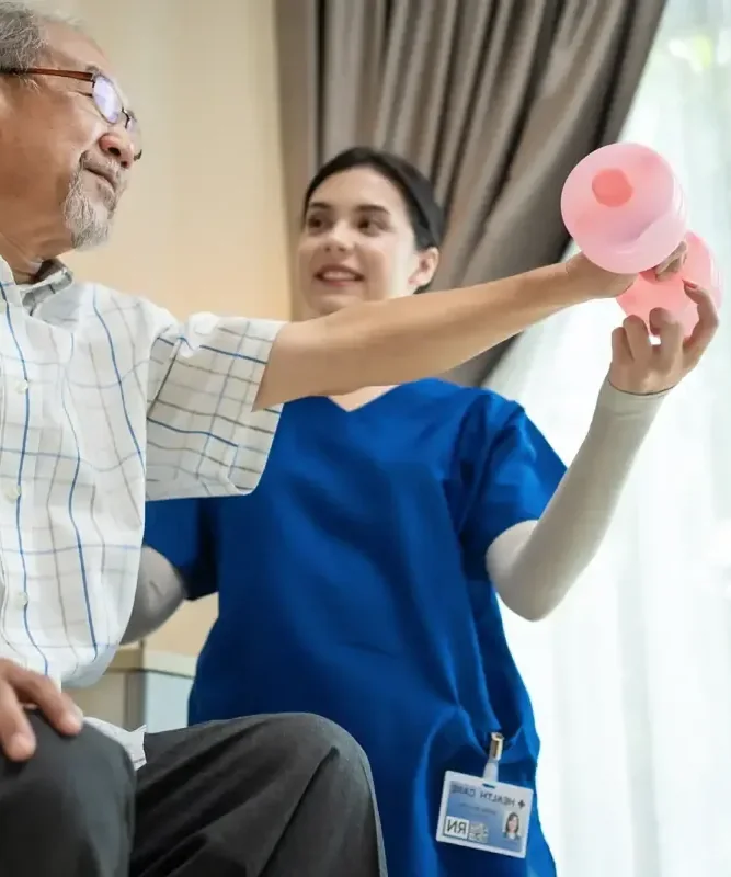 A licensed physical therapist supporting a stroke patient through a supervised walk at King Physical Therapy and Fitness in Connellsville, PA